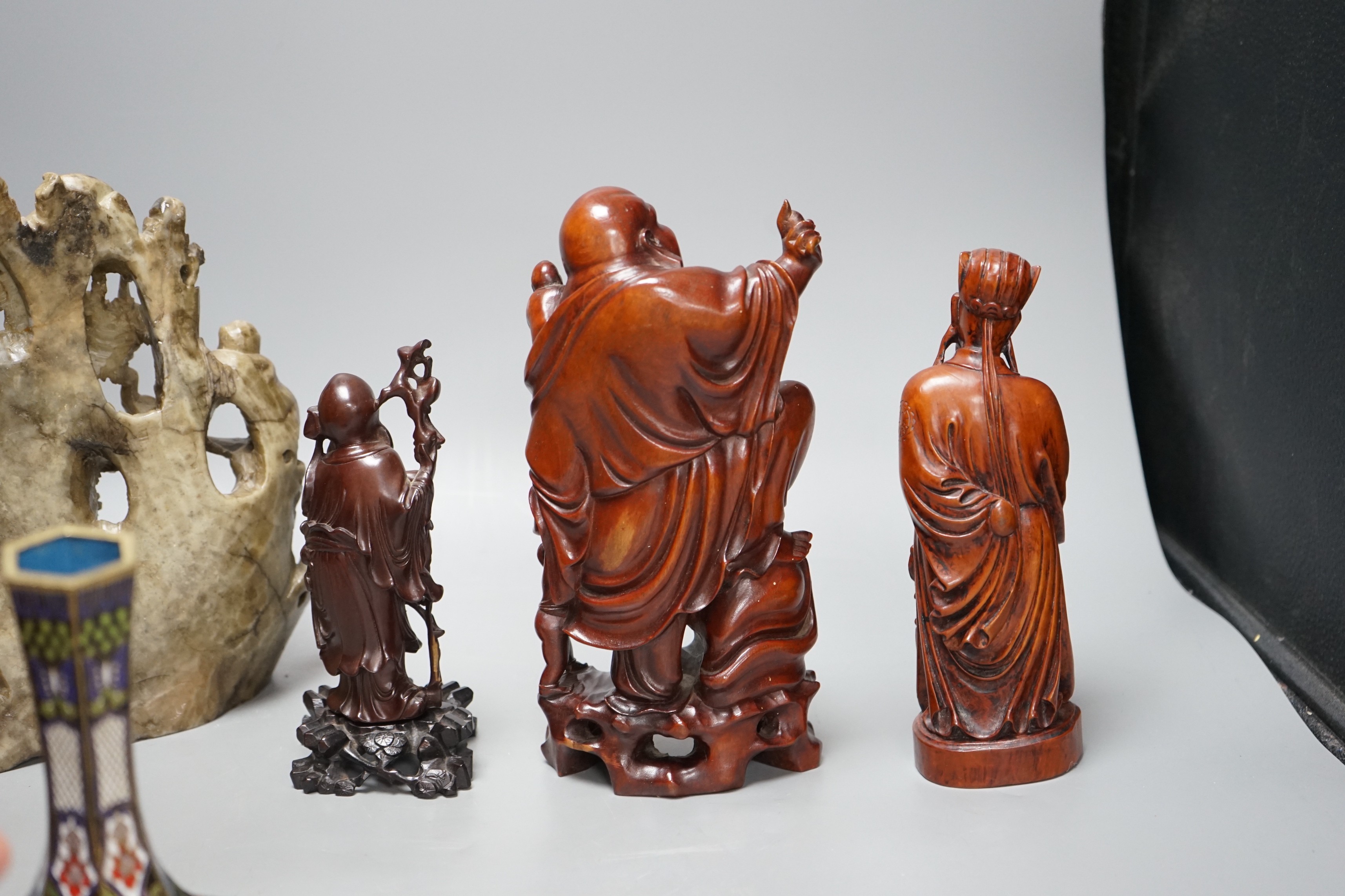 Two Chinese champlevé enamel vases, a soapstone carving and three early 20th century Chinese carved hardwood figures, tallest 26cm